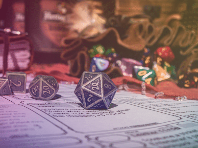 A stock image of D20 dice on a Dungeons & Dragons character sheet with an added rainbow gradient.