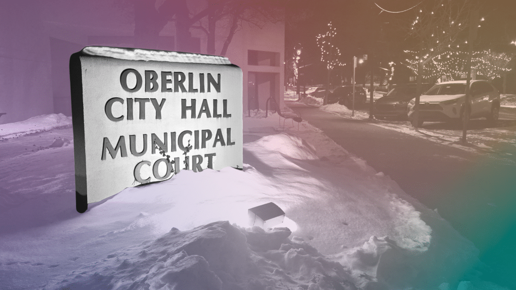 The sign for Oberlin City Hall and Municipal Court is in black and white. The background is a nearby street with a rainbow gradient.