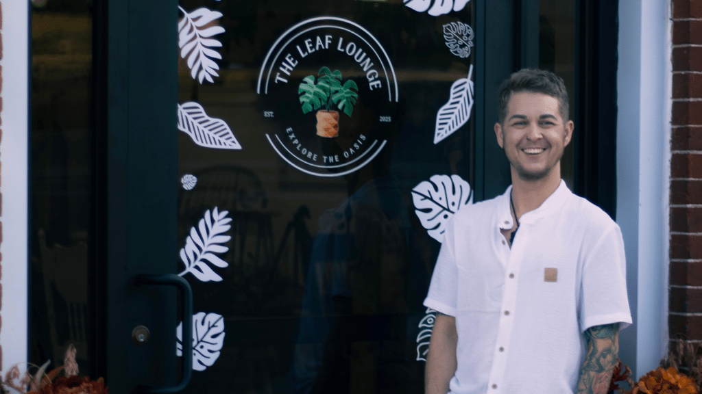 Kayden Warner, owner of The Leaf Lounge, stands in front of his business.