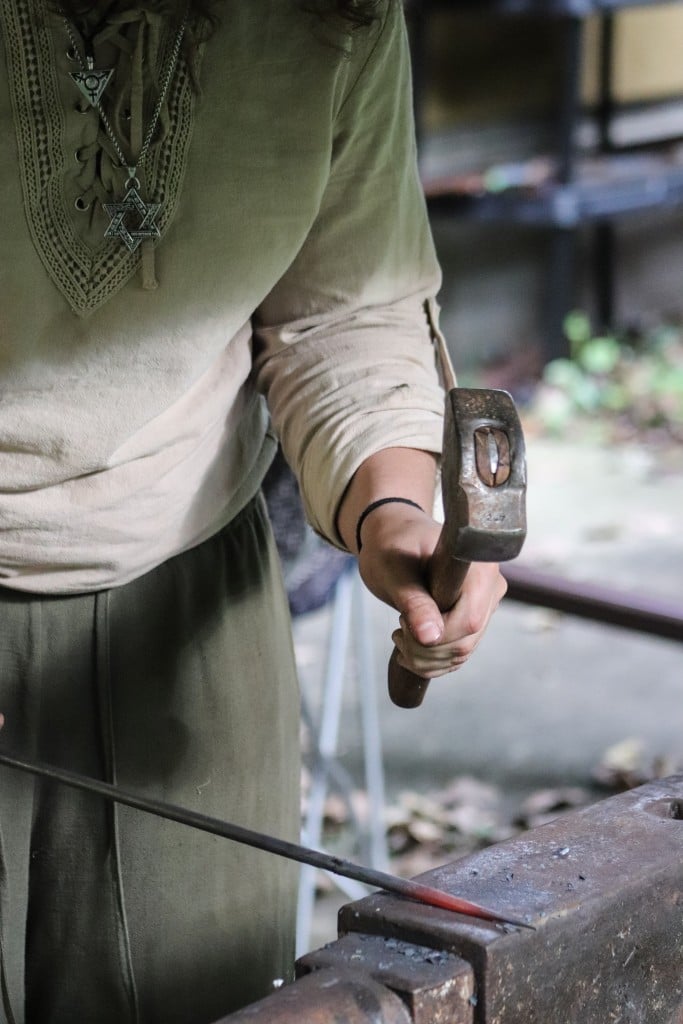 Rose Solomon swings her hammer to shape metal.